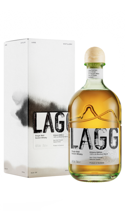 A bottle of LAGG Single Malt Kilmory Edition 70cl, aged in bourbon casks, stands next to its matching box, showcasing a light golden hue. The design features bold black lettering on both the bottle and box, complemented by artistic black brushstroke elements that enhance its finish.