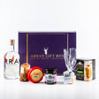 The "Deluxe Gin Lover Arran Gift Box" is a delightful treasure for any gin enthusiast, showcasing a bottle of Arran gin, an Isle of Arran cheese wheel, chutney, oatcakes, a soap bar, and sweet treats. Encased in a purple box with gold accents, it offers an exquisite taste of the Isle of Arran.