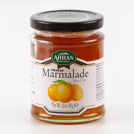 A jar of Fine Cut Orange Marmalade, crafted in traditional style by Arran Fine Foods, features a vibrant illustration of orange and lemon slices. With a net weight of 12 oz (340g), it is elegantly sealed with a black lid.