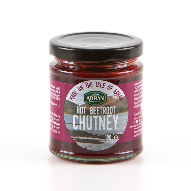 A 190g jar of Hot Beetroot Chutney, crafted by Arran Fine Foods, features a purple label with the tagline "Made on the Isle of Arran," offering a flavorful mix with a touch of hot chili and embodying the beauty of a picturesque coastal setting.