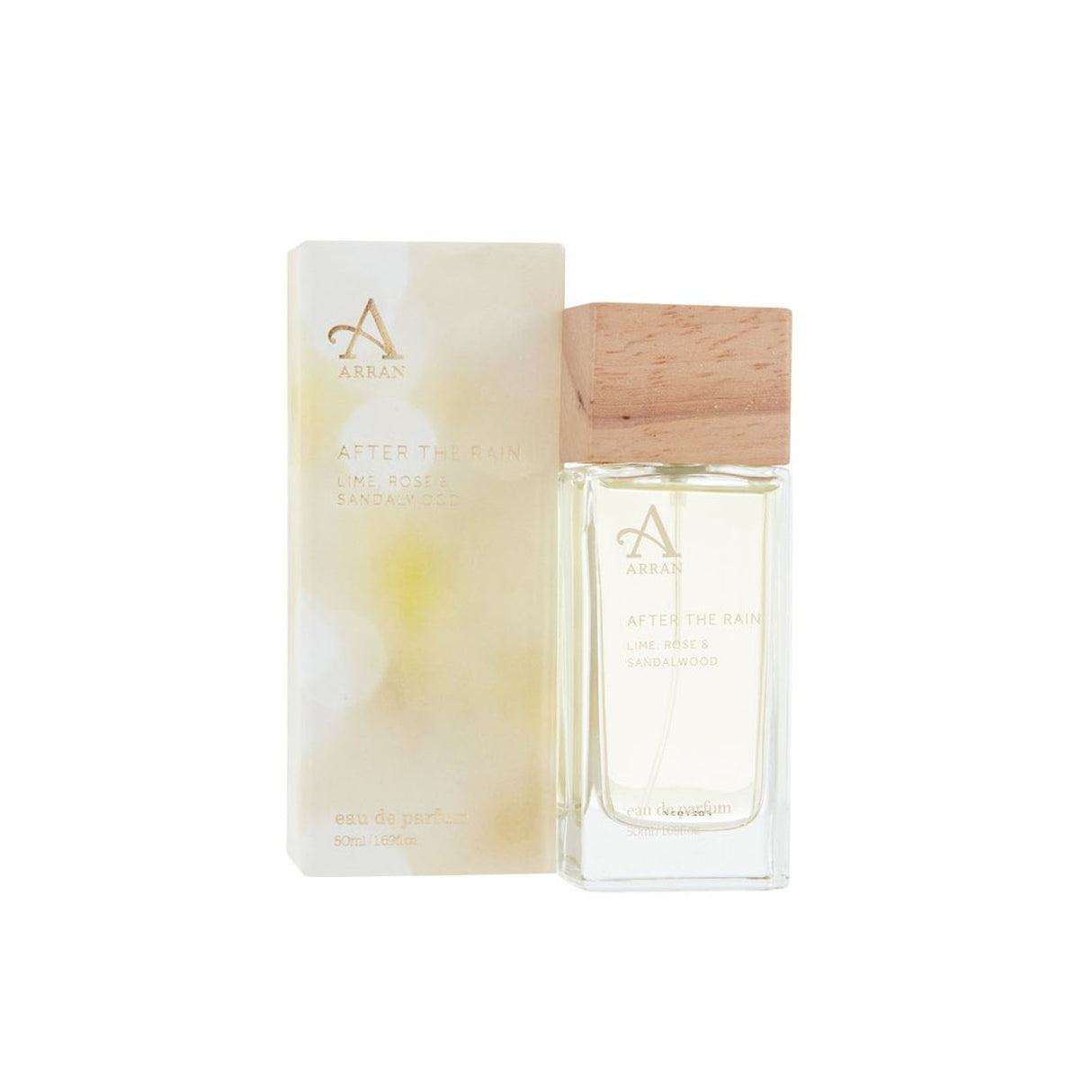 A bottle of After the Rain Eau De Parfum 15ml sits next to its box. The bottle, featuring a wooden cap, holds a clear liquid. The white box adorned with gold lettering and an artistic design suggests the fresh and invigorating fragrance notes of lime, rose, and sandalwood, seamlessly blending subtle florals and woody undertones.