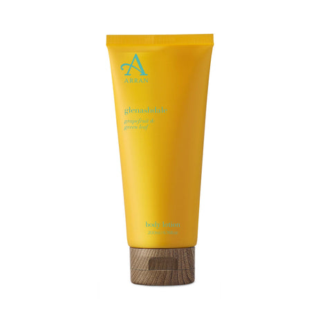 A 200ml tube of Glenashdale Body Lotion, featuring a grapefruit and green leaf scent in a yellow packaging with blue text and a wooden-look cap.