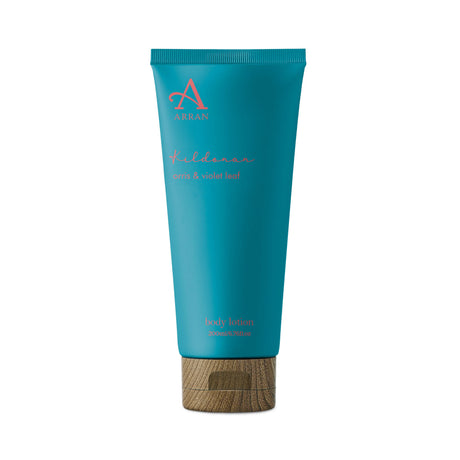 A teal tube of Kildonan Body Lotion 200ml featuring a blue and violet leaf scent, with coral pink text and a wood-like cap, set against a white background.