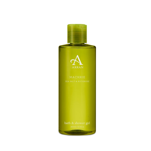 A bottle of Machrie Shower Gel 300ml, adorned with the "Sea Salt & Rockrose" label, features a green cylindrical design and a flip-top cap. Its capacity is 300ml or 10.1 fl oz.