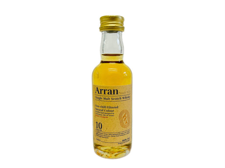 A miniature 5cl bottle of Arran 10-year-old Single Malt Whisky, perfect for any whisky enthusiast. The clear glass displays the golden liquid inside, complemented by a beige label that highlights the brand name and provides details about this exquisite 10-year-old malt's age and characteristics.