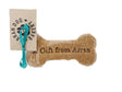 The Handmade Arran Dog Bone Biscuit is a vegetarian dog treat shaped like a bone, featuring the text "A Gift from Arran." It includes a brown tag with the "Arran Dog Bakery" logo and is decorated with a turquoise ribbon. This delightful biscuit, made from natural ingredients, is wrapped in clear packaging.