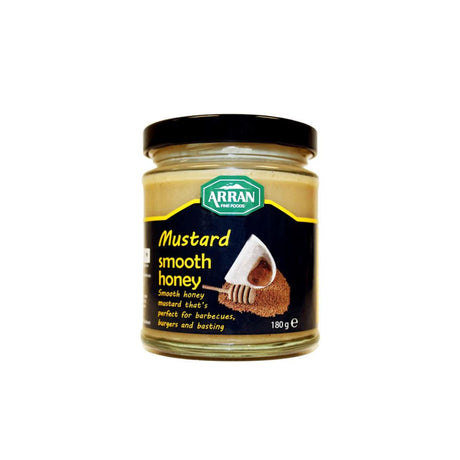 A jar of Smooth Honey Mustard from Arran Fine Foods, topped with a black lid. The label showcases an image of the mustard alongside a honey dipper and highlights that it is "perfect for barbecues, burgers and basting." Made with premium ingredients, its net weight is 180g.