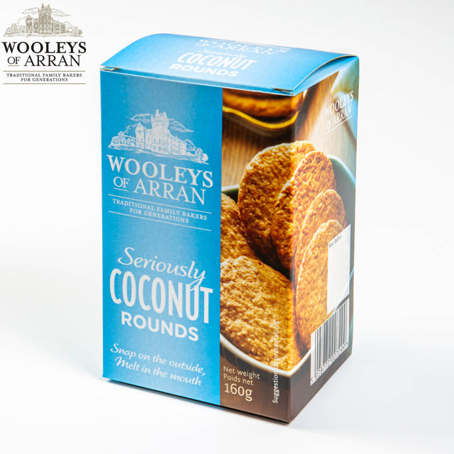 Wooleys of Arran Seriously Coconut Rounds biscuits are packaged in a delightful blue box that provides a sneak peek at the cookies inside. These 160g treats are distinguished by their "Snap on the outside, melt in the mouth" texture, offering a distinctive twist from conventional oatcakes.