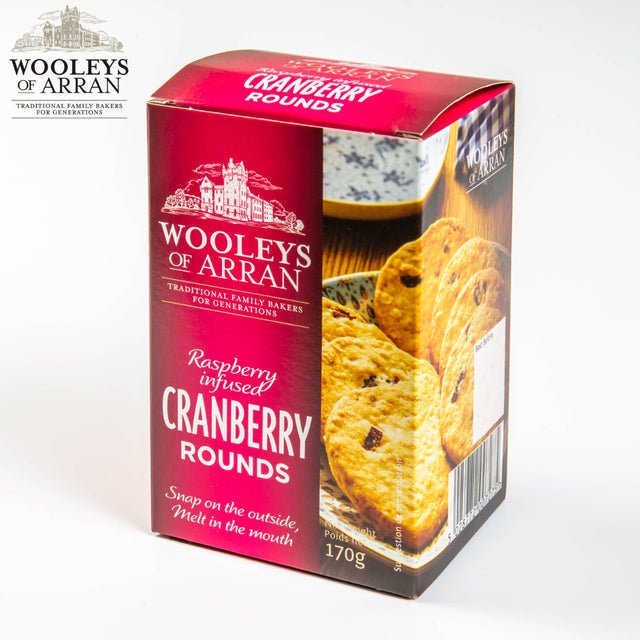 A boxed package of "Wooleys of Arran" Raspberry Infused Cranberry Rounds. The box features an image of the baked goods and accentuates their texture: "Snap on the outside, Melt in the mouth." The 170g package promises a delightful fusion of flavors from Arran's finest.